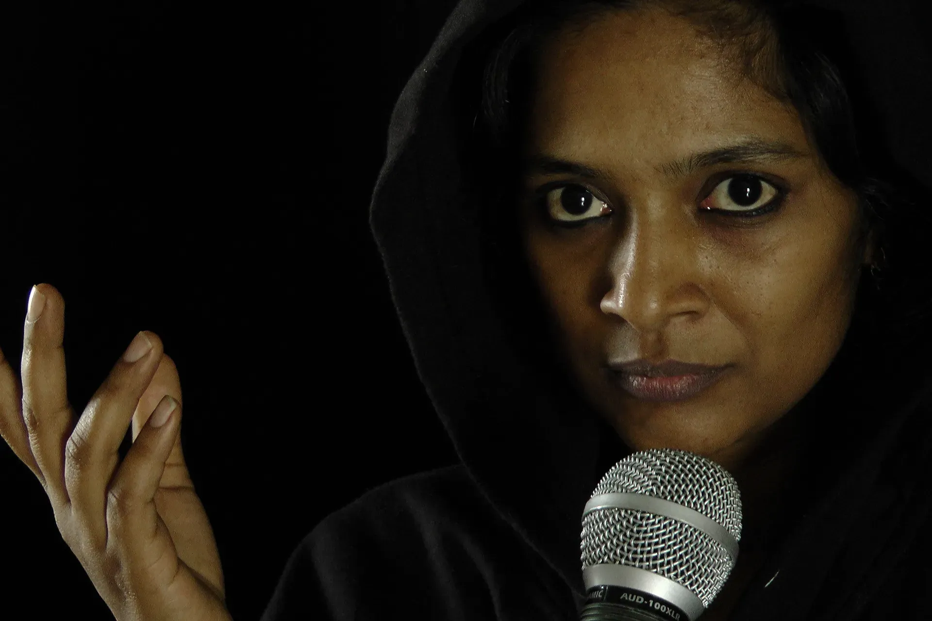 actress with microphone on stage, close up