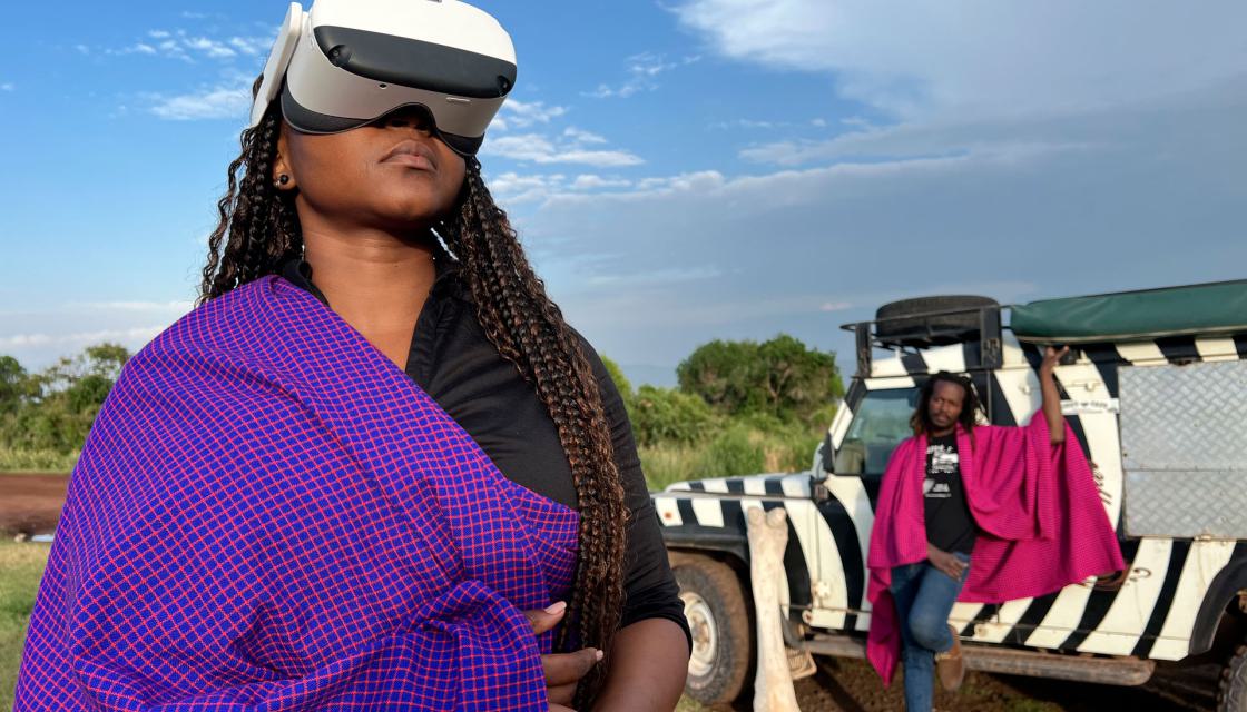 2 people on a safari, 1 in the back and 1 with a VR glass